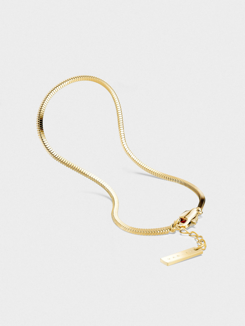Gold chain bracelet on a light gray background